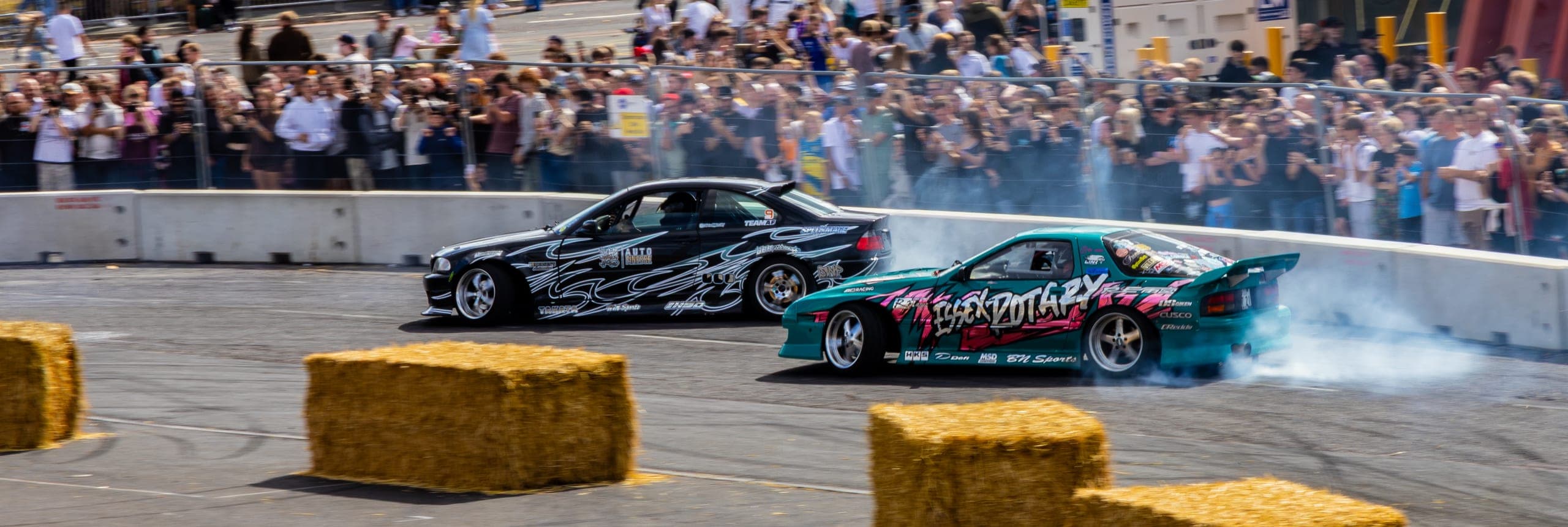 A liveried drift car sideways in front of a large crowd, Gravity 2026