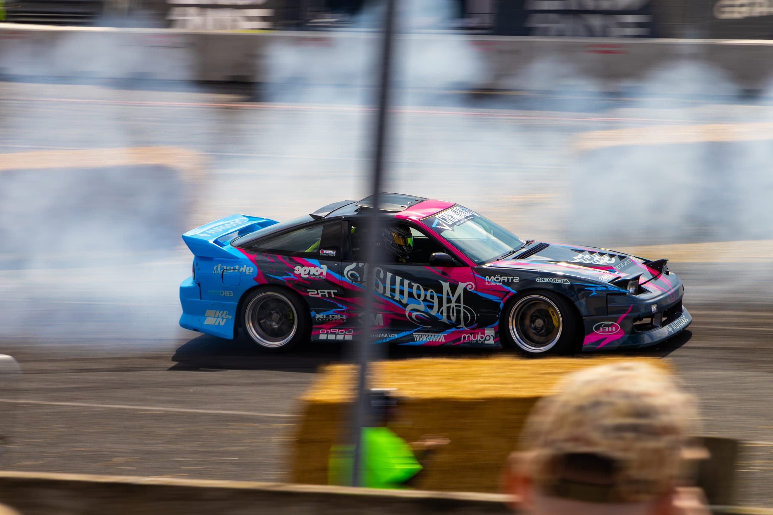A high-winged drift car pouring smoke off the rear tyres, Gravity 2026