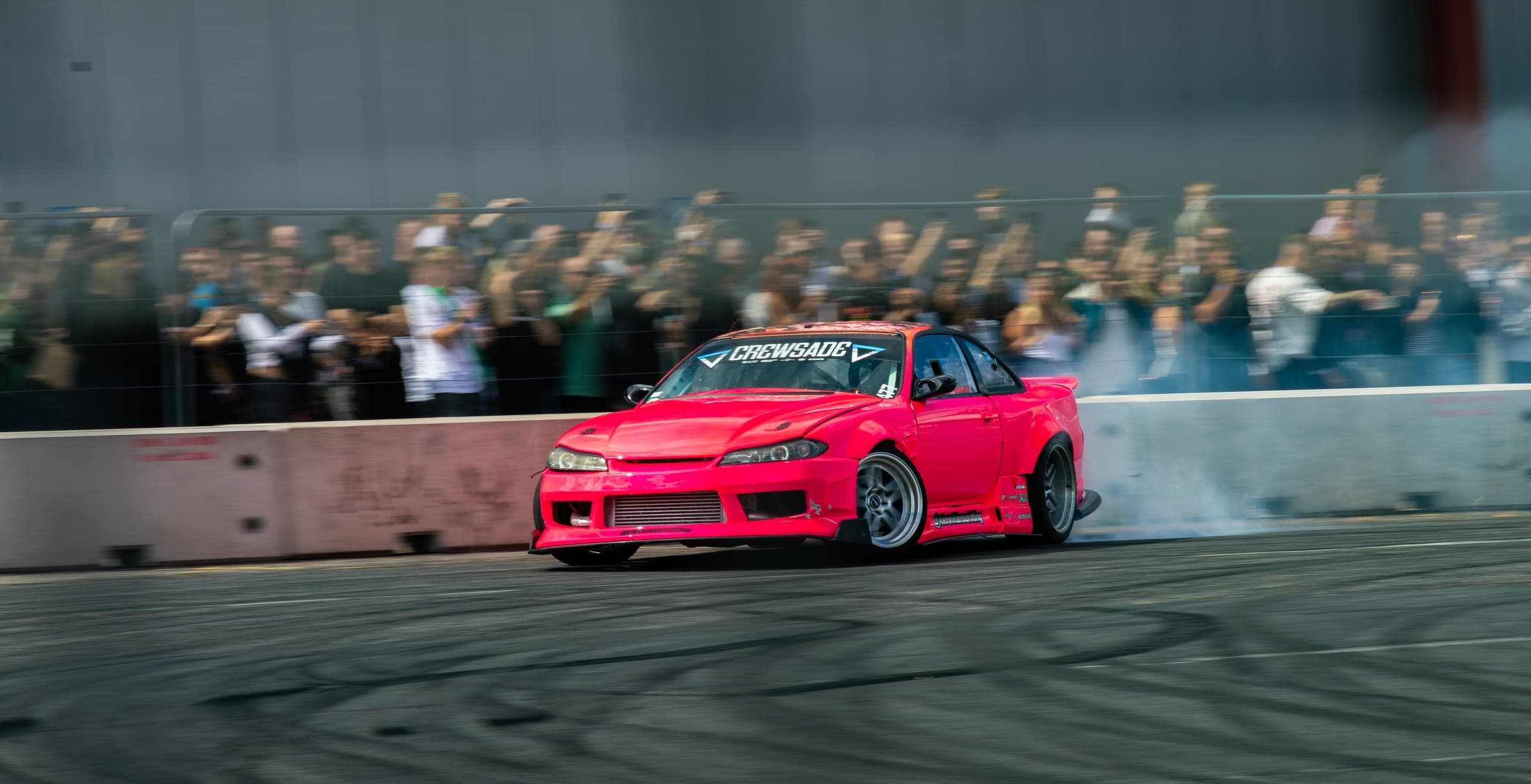 A pink drift car head-on with the crowd behind, Gravity 2026