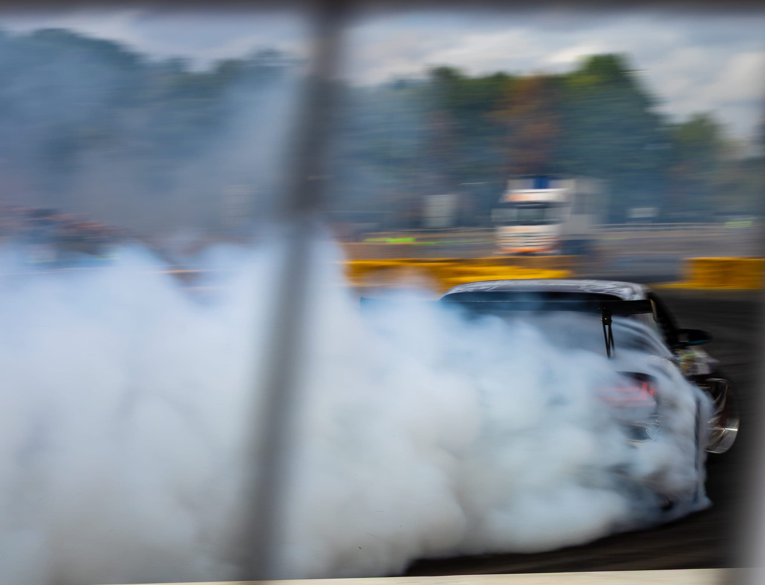 A drift car dissolving into a wall of tyre smoke, Gravity 2026