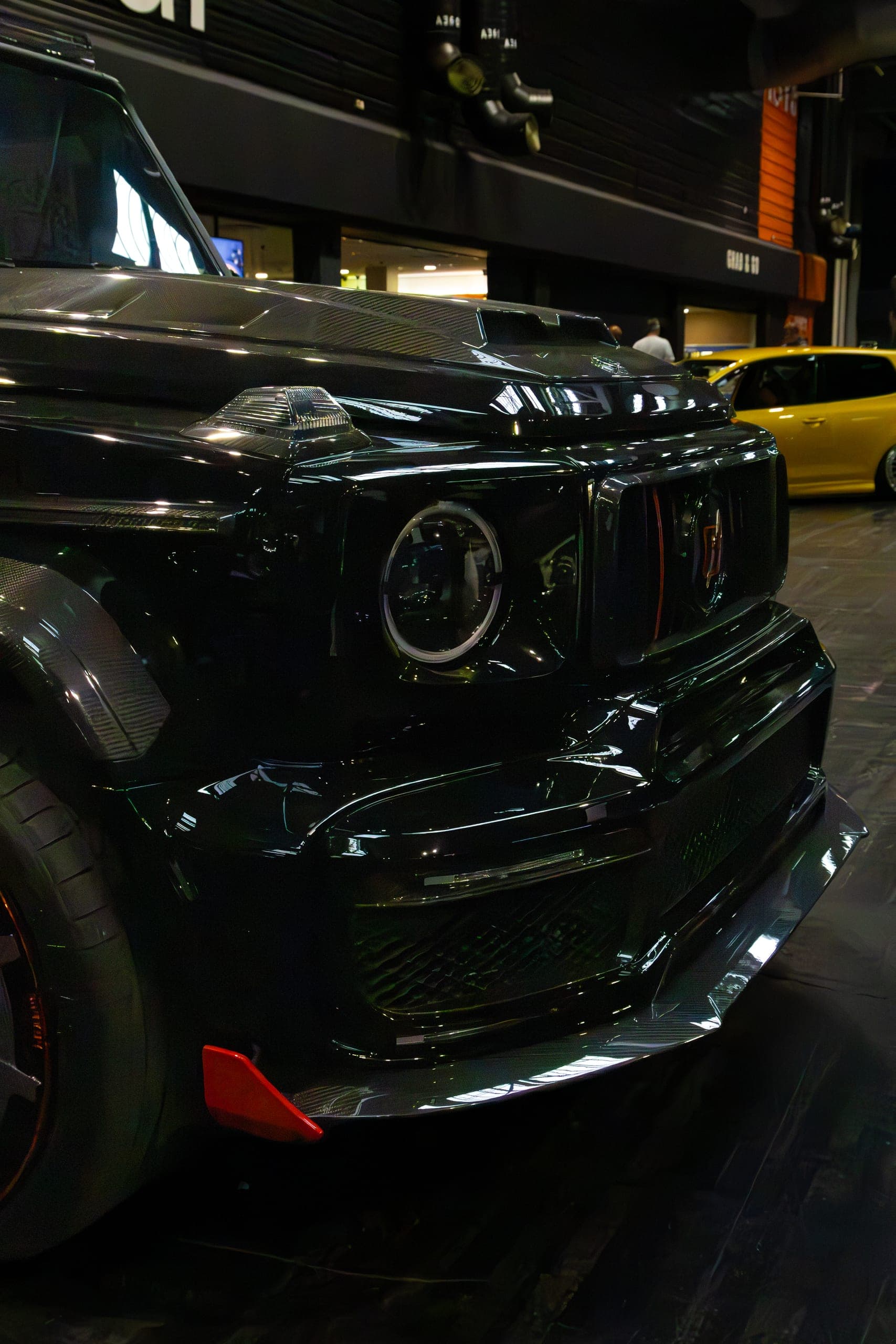The front end of a blacked-out show car, Gravity 2026