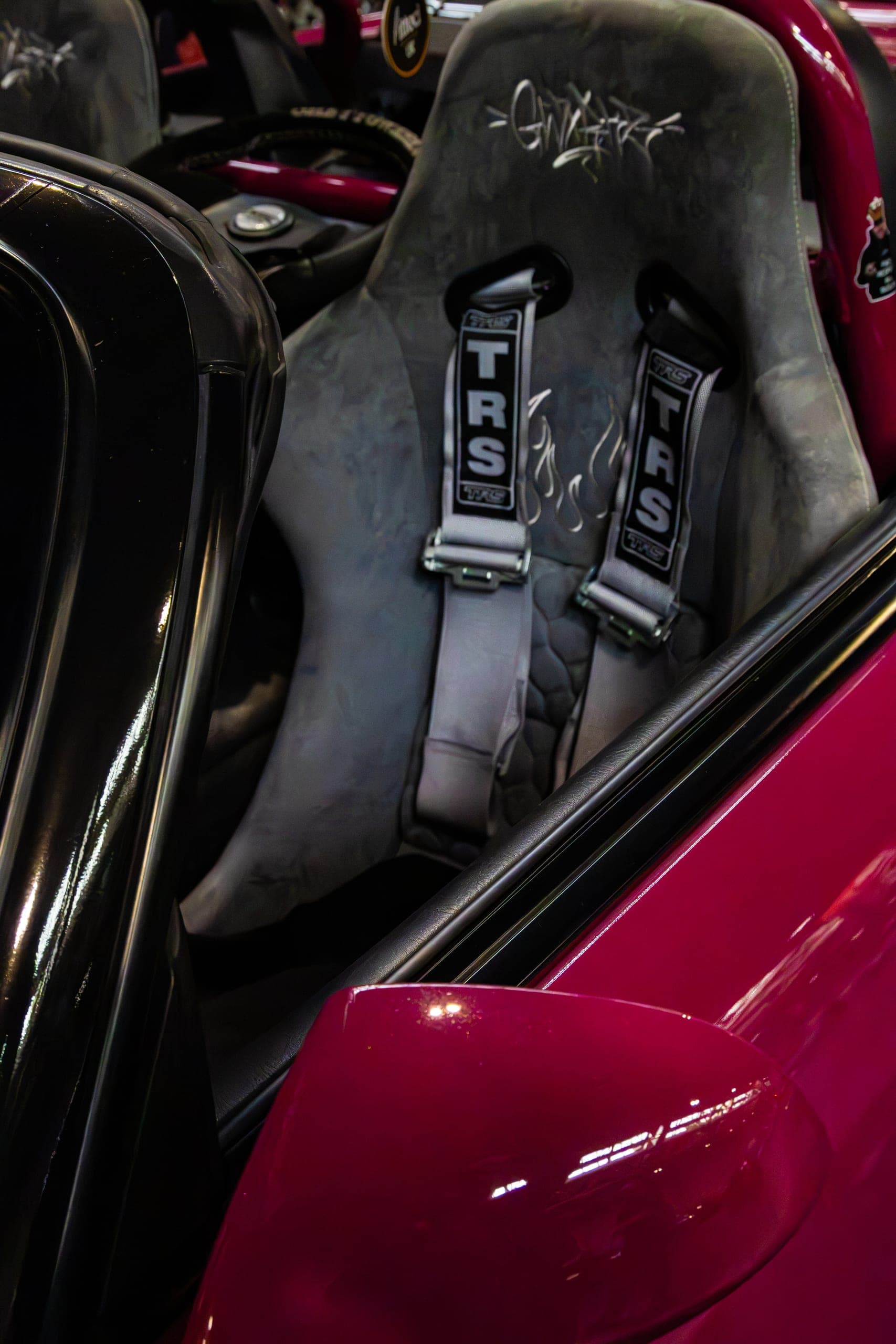 Racing harnesses across a bucket seat, Gravity 2026