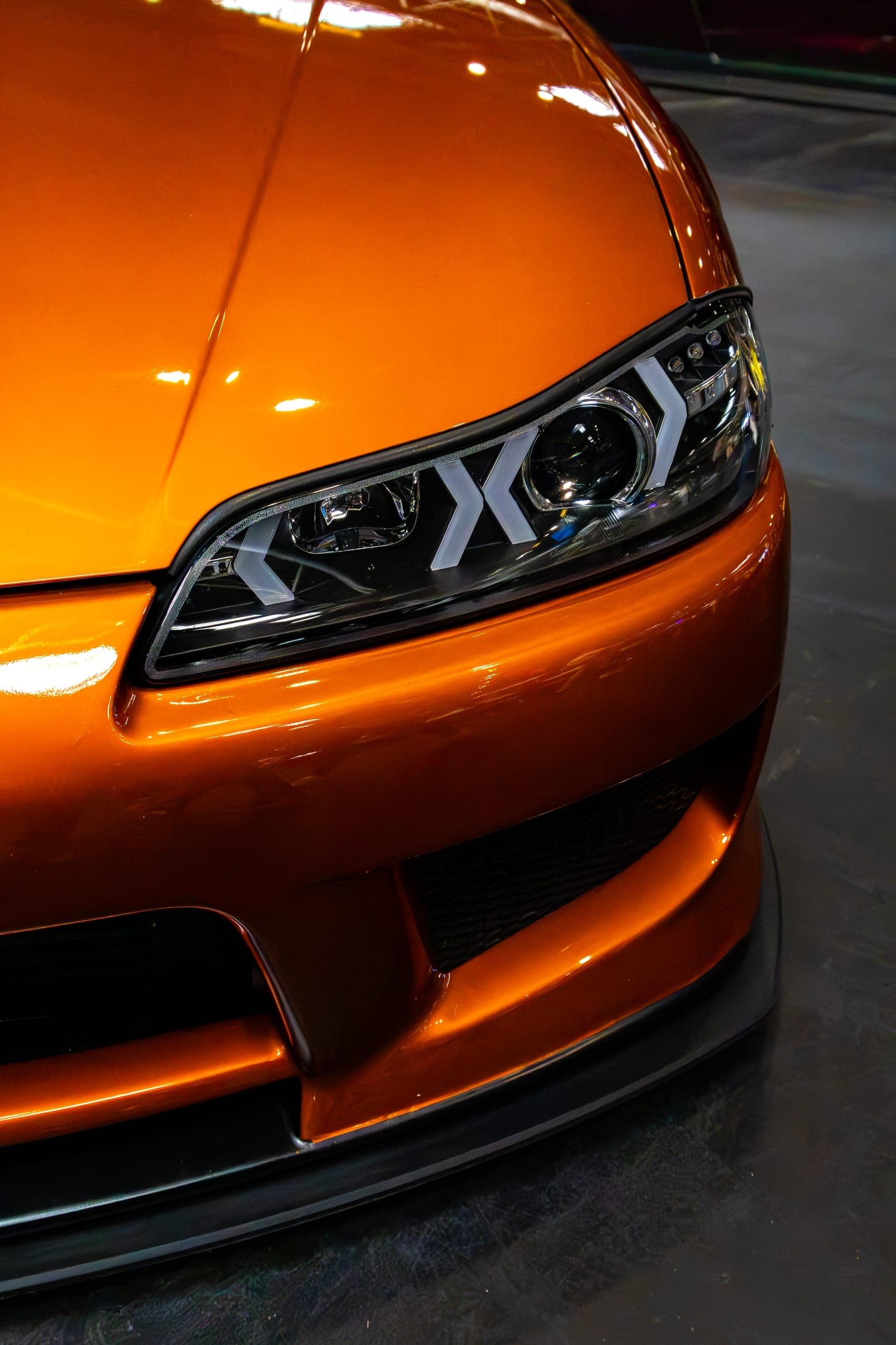 A tight front three-quarter of an orange show car, Gravity 2026