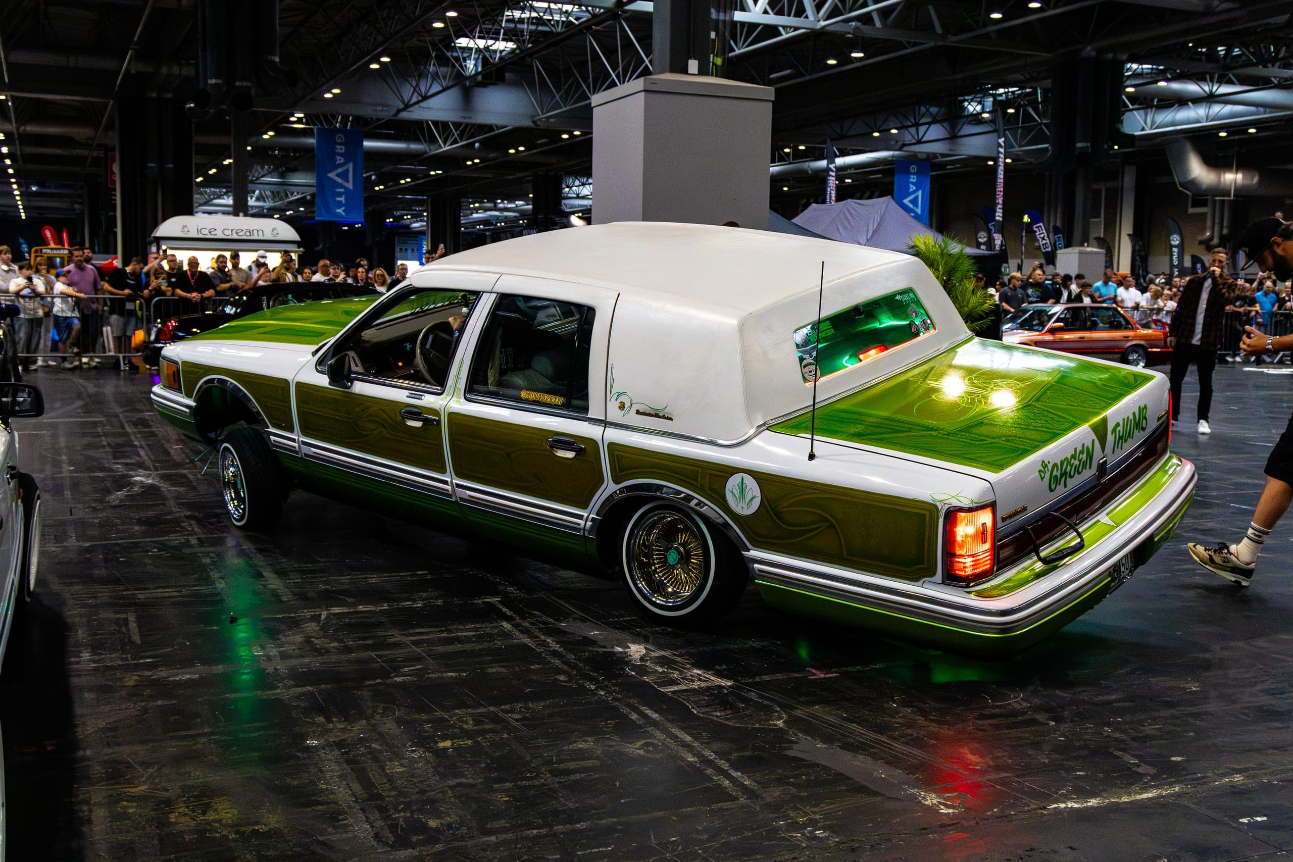 A green and white show car under the hall lighting, Gravity 2026